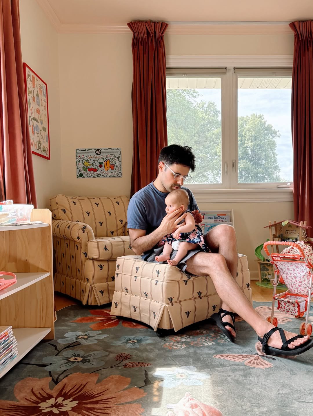 Victoria’s partner holding their baby daughter Lulu in the nursery